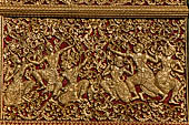 Wat Xieng Thong temple in Luang Prabang, Laos. Detail of the  gilded wood carvings of the facade of the Royal Funerary carriage hall. 